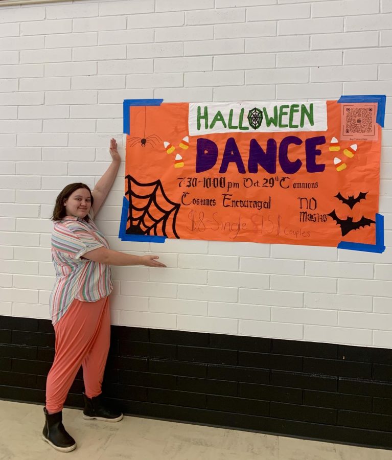 Art Club President, Aurora Dunn proudly displays one of the clubs poster for the Halloween Dance.
