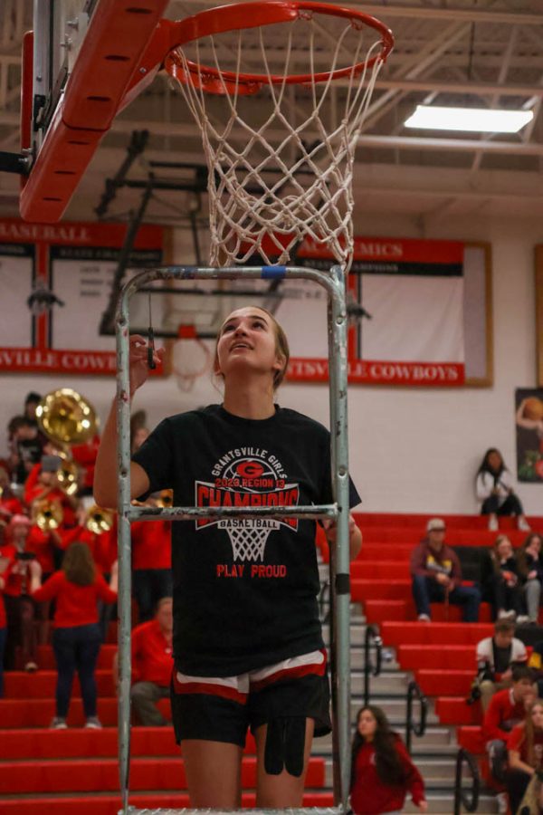Afton orgill cutting the net after for tradition of region champs  