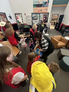 Preschoolers in the counseling center getting candy from the staff