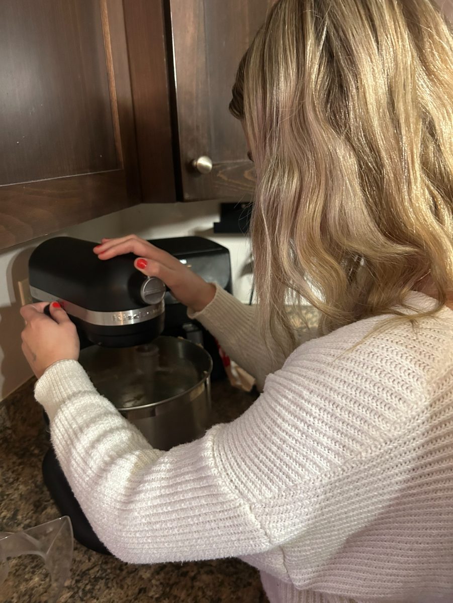 Brooklyn Olson mixing cookie dough on December 1, 2023