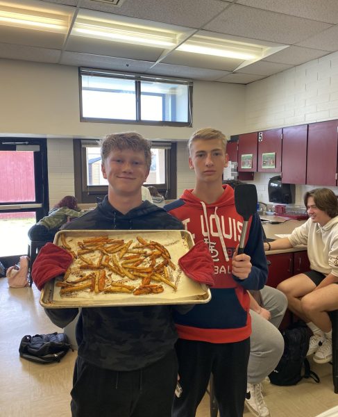Marshall Butler, Carson Anderson in foods class holding fries 