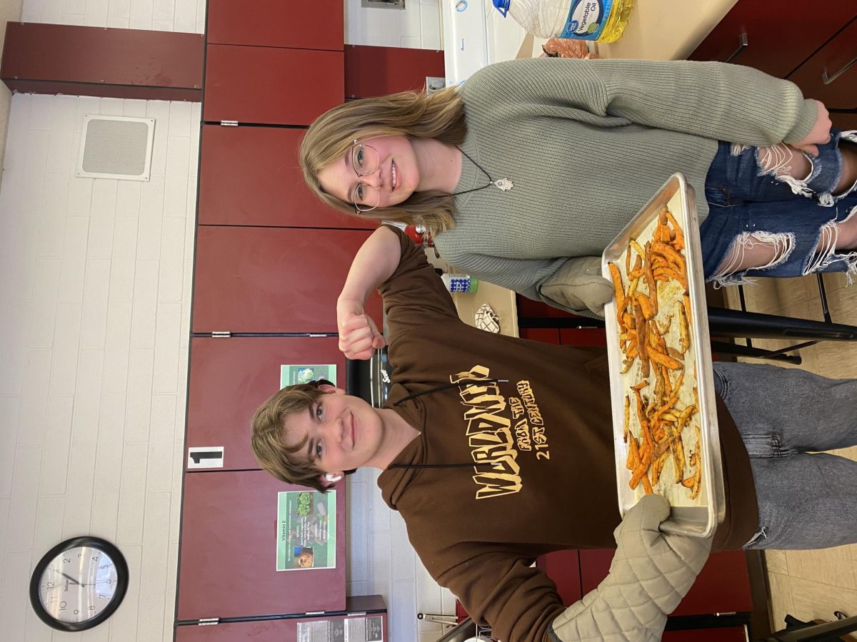 Claire Curtis, Jacob Olsen in foods class holding fries 