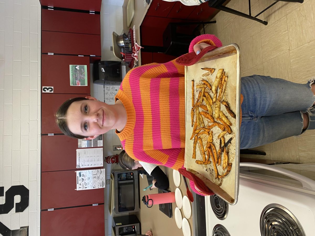 Afton Hislop in foods class holding fries 