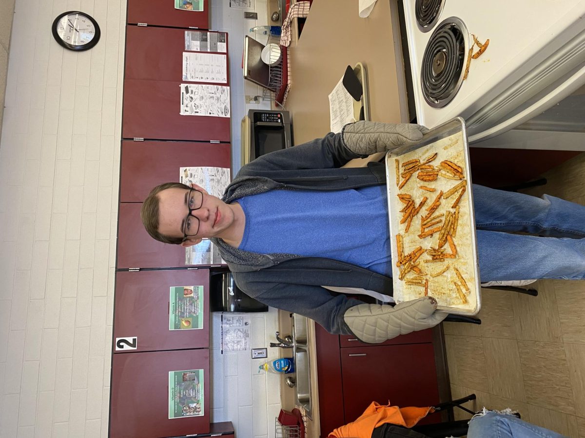 Preston Sargent in foods class holding fries 