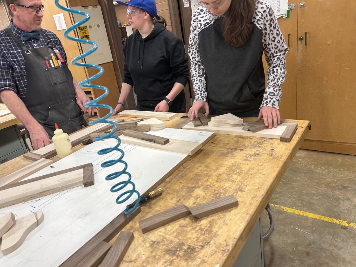 Teacher Jeff Goodsell and Brie OConnor working on a shelf