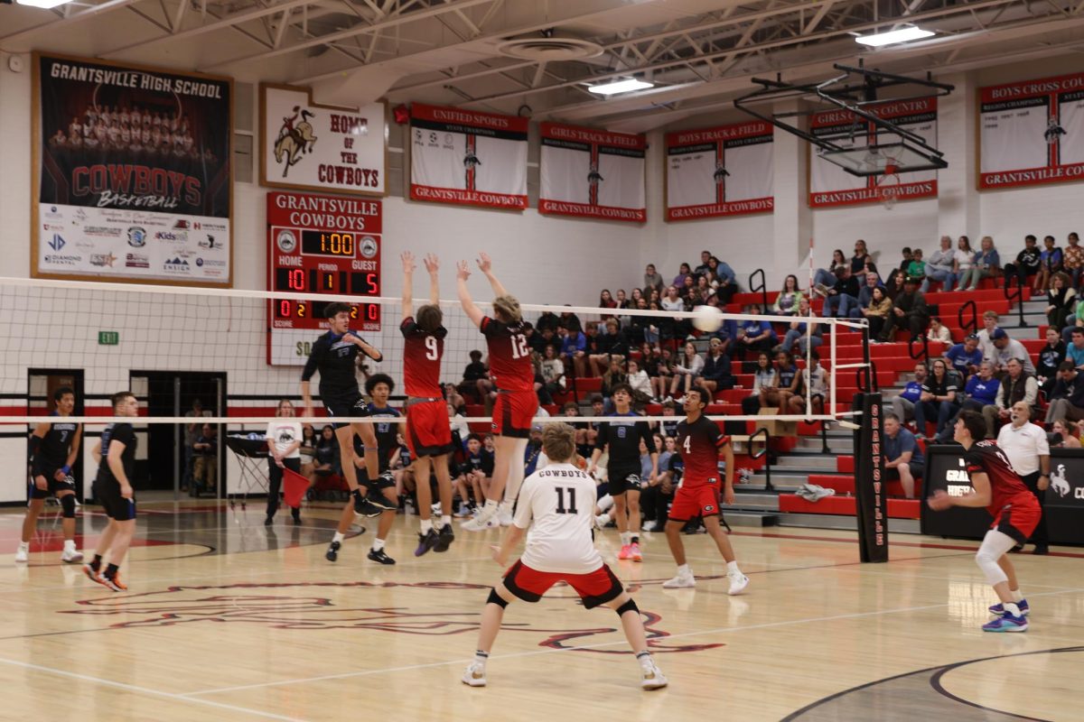 #9 Joe Bailey and # 12 Max Crithclow attempting the block as #3 Decker Dzierzon receives the ball
