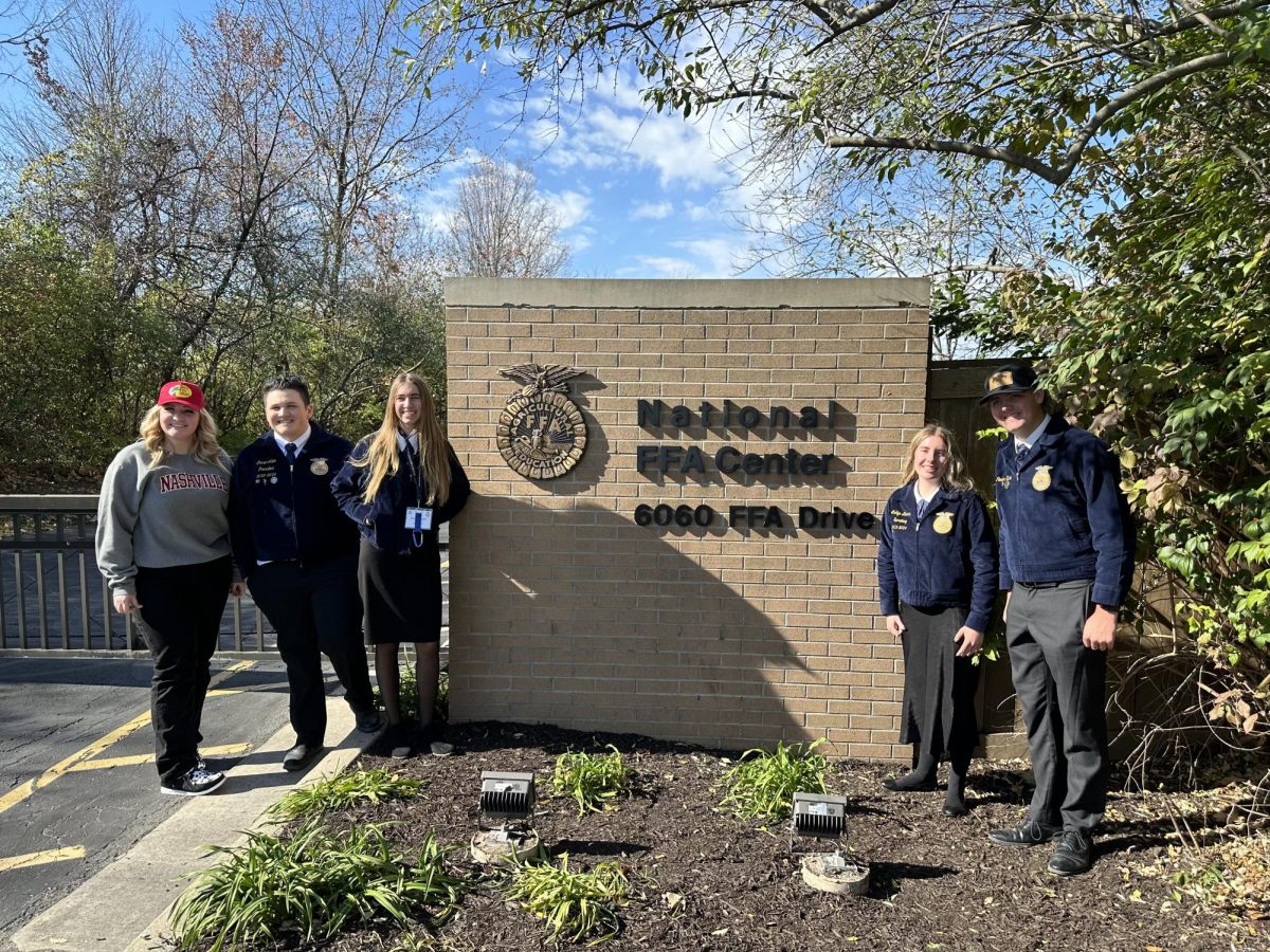 Raylin Shultz taking a photo with her friends on an FFA trip.