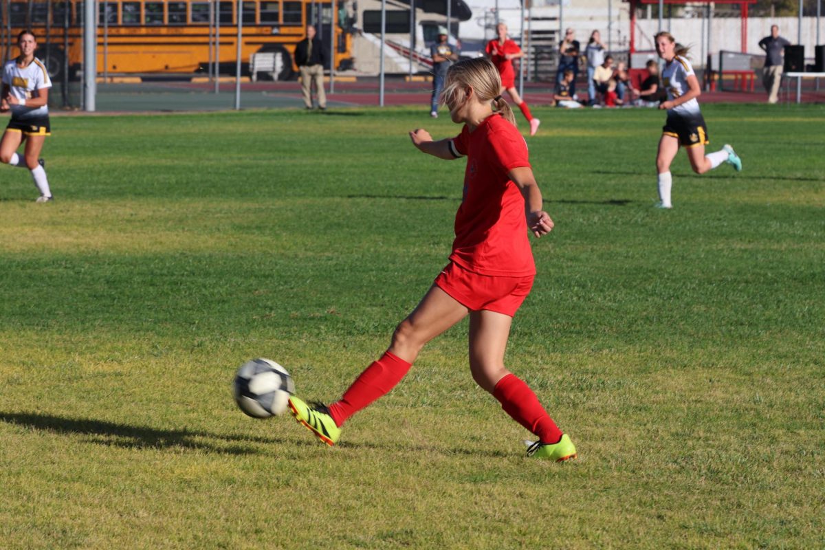 Lissy Lee kicking ball to team mate against Union at playoffs 