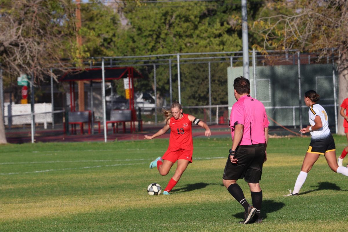 Madison Eggett kicking ball to team against Union playoff game