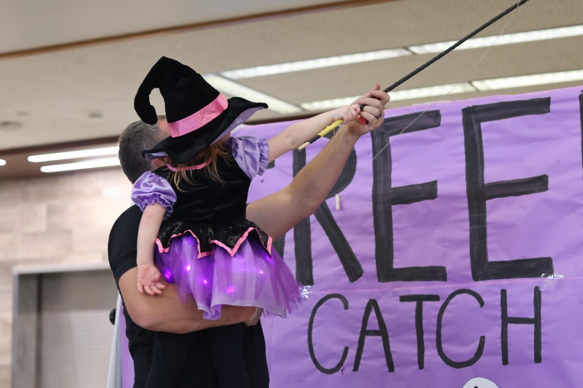 Daughter and Father at Halloween carnival playing creepy catch