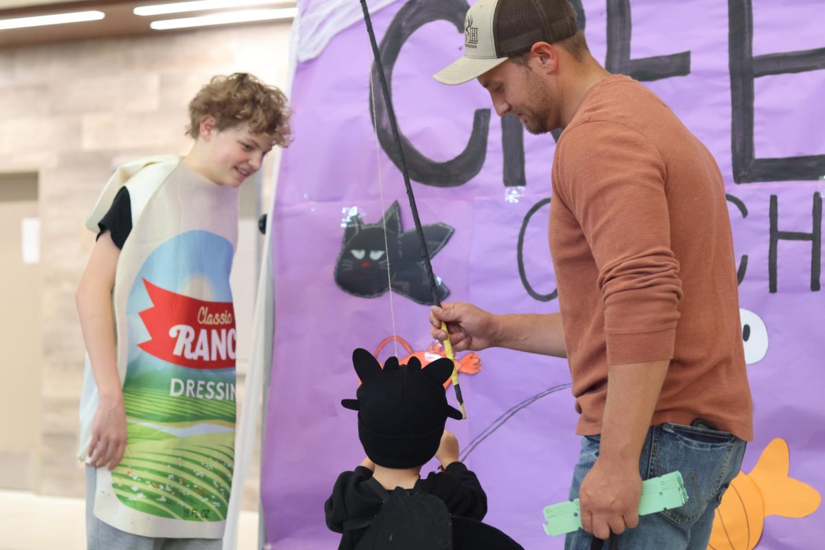 Jaren Keyes, child and father at the Halloween carnival playing creepy catch 