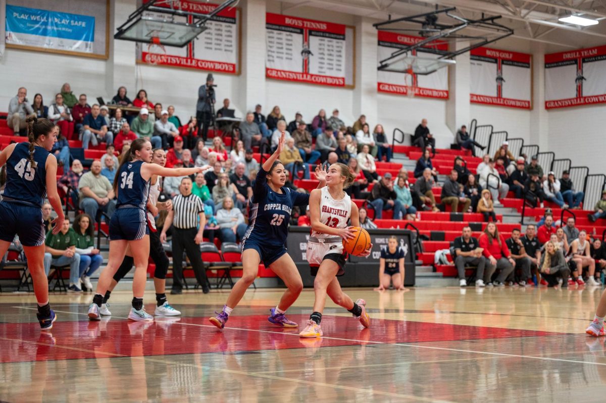 Afton Orgil going in to the hoop against 25 on copper hills